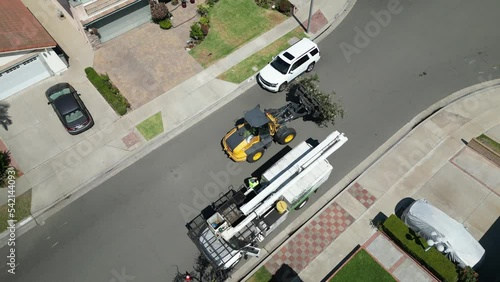 Aerial view of cars and heavy equipements in a village on a sunny day photo