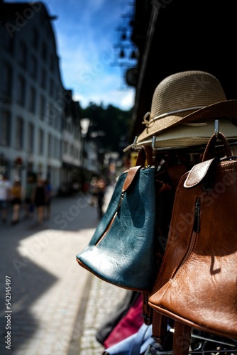 Vertical shot of hats and bags for sale in a street market in Monschau