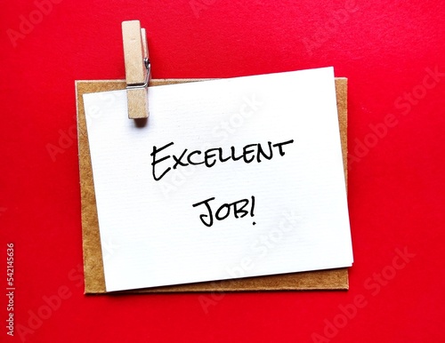 Note on red background with text EXCELLENT JOB!, to praise someone for something they have done well -Boss or manager recognizing employees for good work