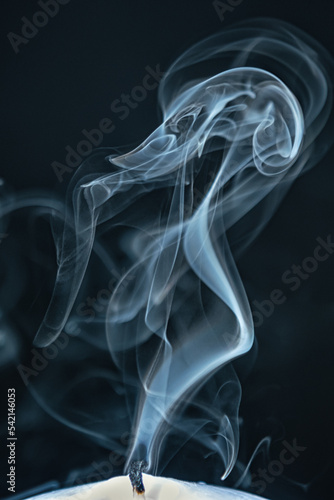 Smoke from a candle on a black background