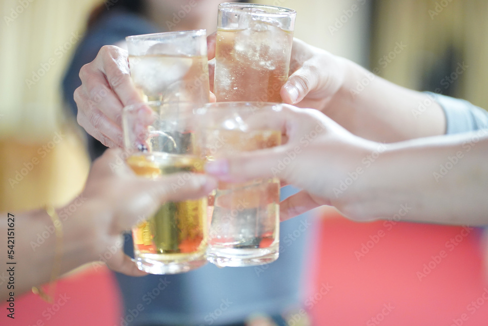 Hands clinking drinking glasses with friends at a fun and happy party.,select focus Hands clinking drinking glasses with friends at a fun and happy party.,select focus