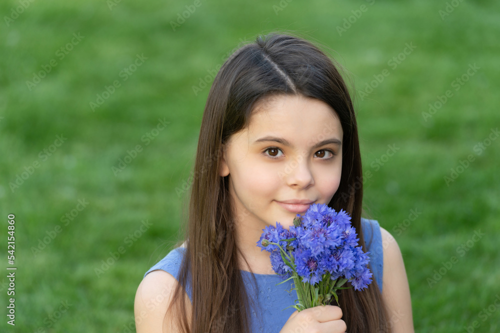 teen girl smelling flowers. pretty girl on grass. cute girl portrait teen girl smelling flowers. pretty girl on grass. cute girl portrait