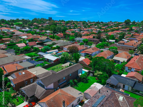 Panoramic Aerial Drone view of Suburban Sydney housing, roof tops, the streets and the parks