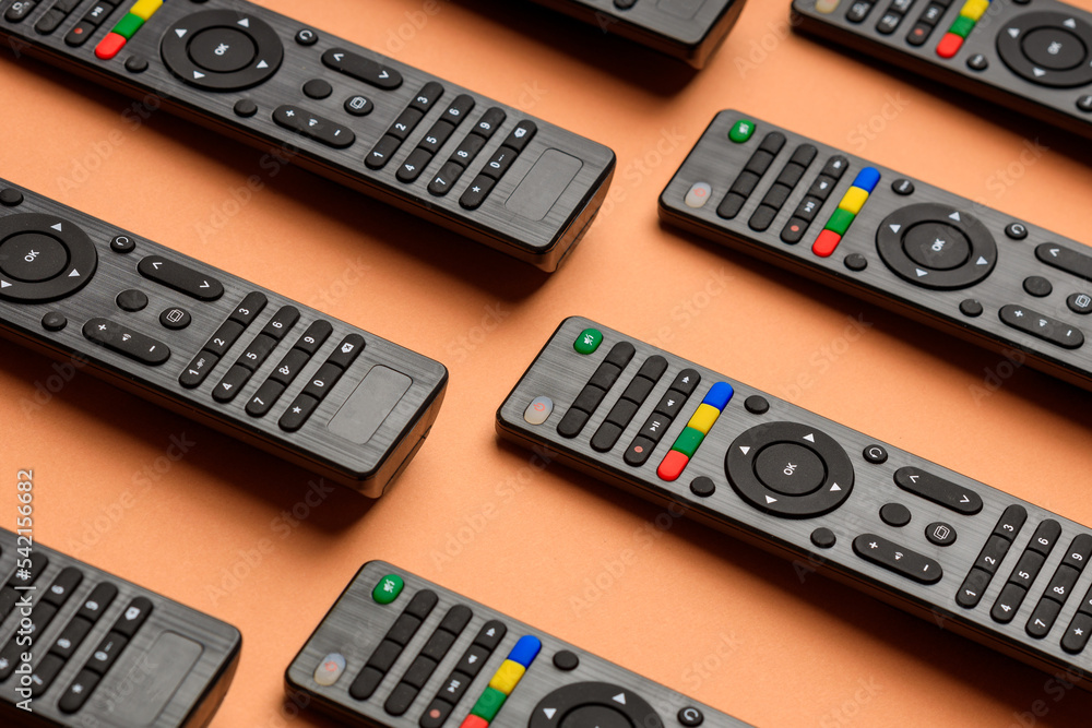 rows of TV remote controls. TV remotes lying on the surface rows of TV remote controls. TV remotes lying on the surface