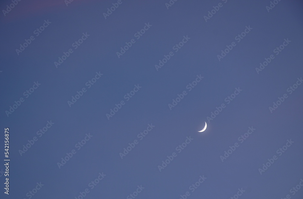 half moon on blue sky in evening half moon on blue sky in evening