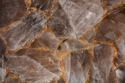 Brown smoky quartz stone slab. Gemstone background. Matt natural semi precious mineral pattern. Semiprecious texture for ceramic wall, floor digital tiles. Material for interior, exterior design. photo