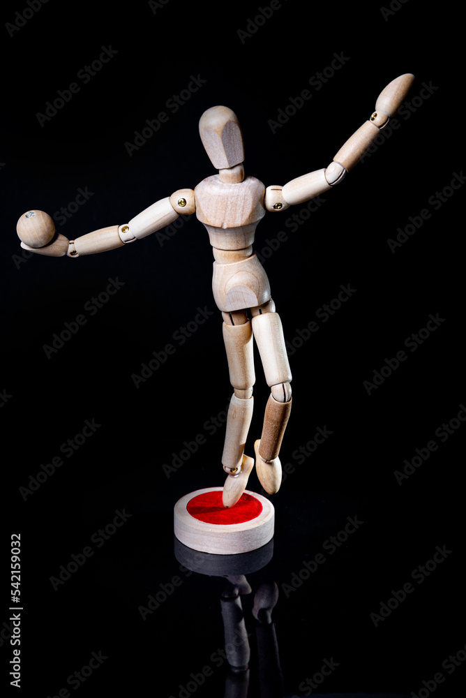 Image of wooden manikin on black background poses different posing Image of wooden manikin on black background poses different posing
