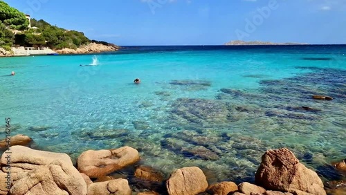 Italy summer holidyas . Sardegna island - stunning Emerald coast  with beautiful beaches. popular Capriccioli beach with red rocks and turquoise sea photo