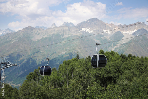 View of cableway with modern cabins in mountains