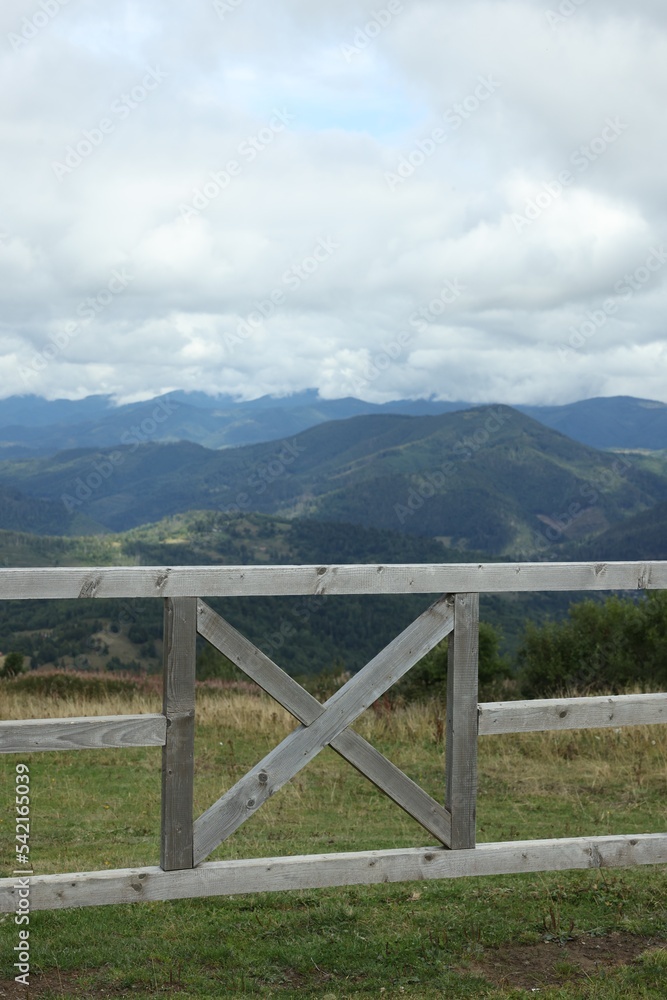 Wooden fence and picturesque view of mountain landscape