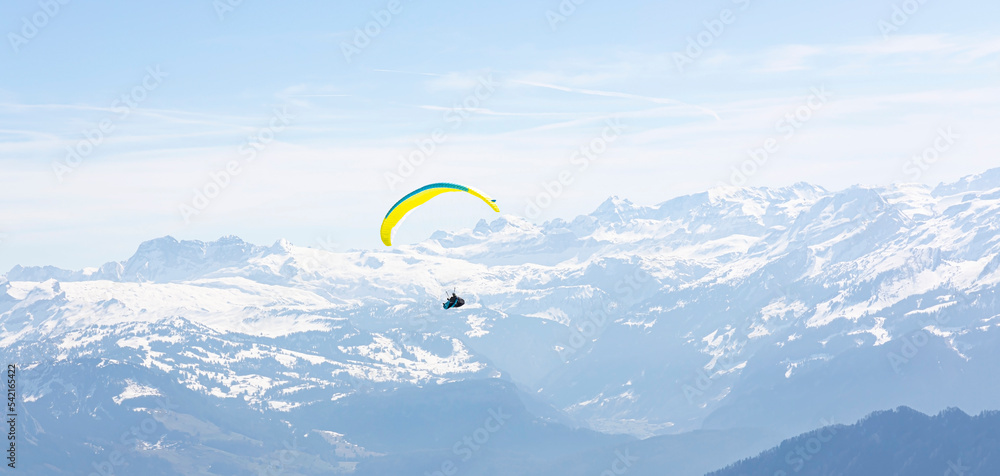 Paraglider Fly in the Mountains as snow apls mountain background Paraglider Fly in the Mountains as snow apls mountain background
