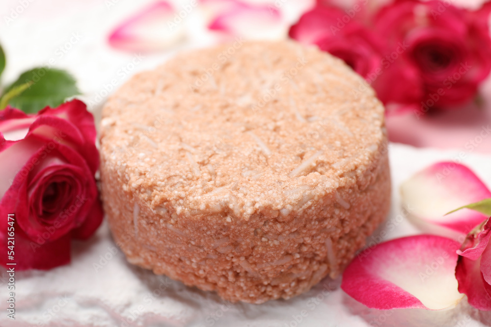 Solid shampoo bar and roses on table, closeup. Hair care Solid shampoo bar and roses on table, closeup. Hair care