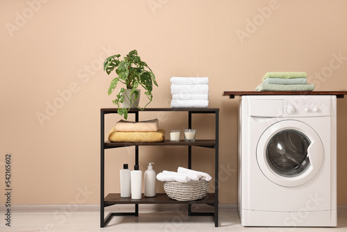 Stylish laundry room with modern washing machine. Interior design