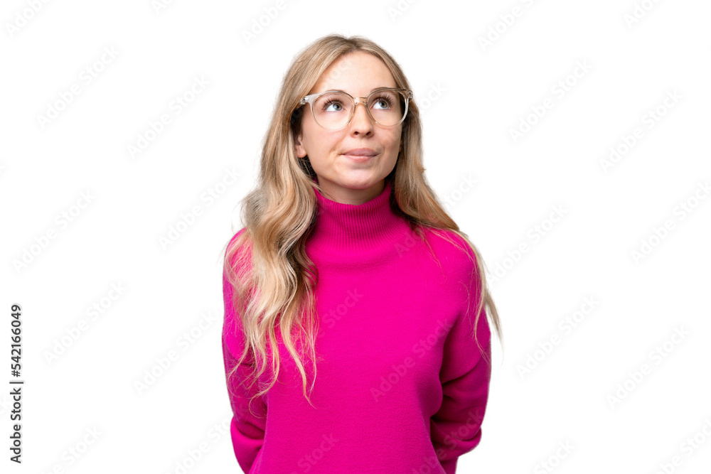 Young English woman over isolated background and looking up Young English woman over isolated background and looking up