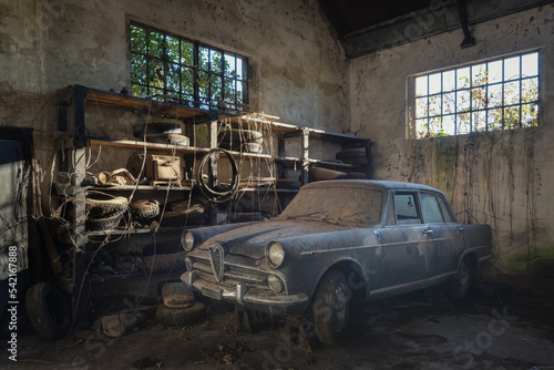An old alfa romeo old timer stored in a garage