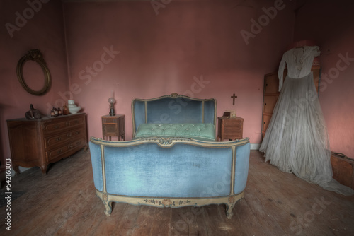 Antique Bedroom decorated in pink with a wedding dress