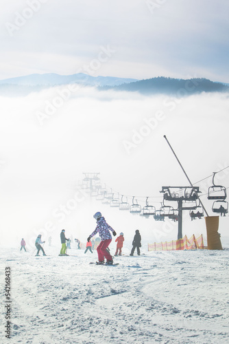 people on the ski slope learning to ride families winter resort