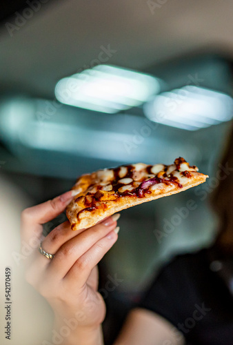 woman Hand takes a slice of chicken Pizza in cafe