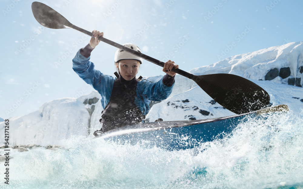 Naklejka premium Woman in a kayak sails on a mountain river. Whitewater kayaking, extreme kayaking.