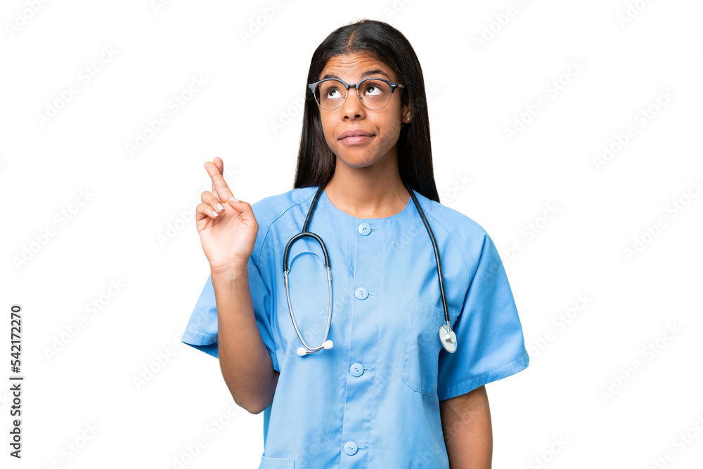 Young African american nurse woman over isolated background with fingers crossing and wishing the best Young African american nurse woman over isolated background with fingers crossing and wishing the best