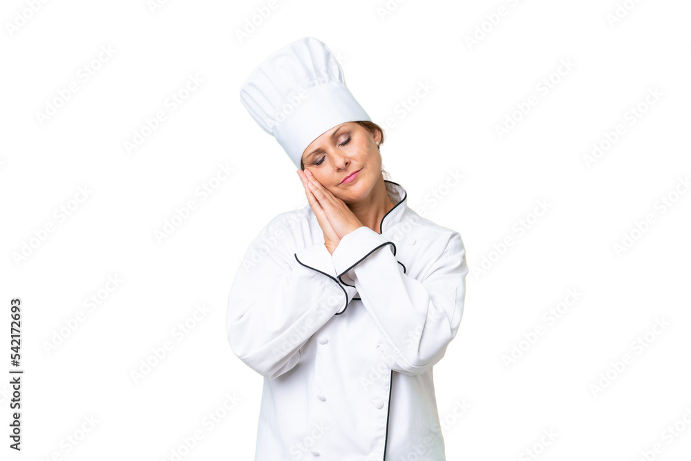 Middle-aged chef woman over isolated background making sleep gesture in dorable expression Middle-aged chef woman over isolated background making sleep gesture in dorable expression