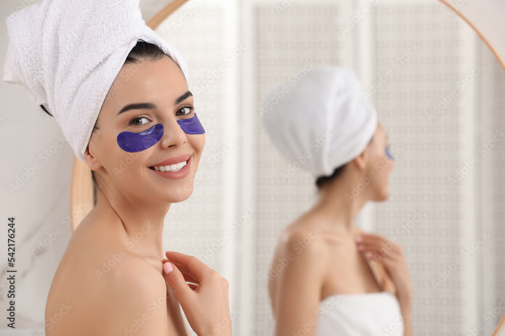Beautiful young woman with under eye patches at home, space for text Beautiful young woman with under eye patches at home, space for text
