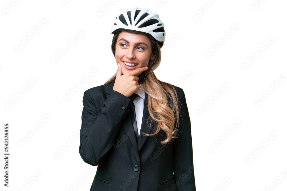 Business Uruguayan woman wearing a helmet biker over isolated background looking to the side