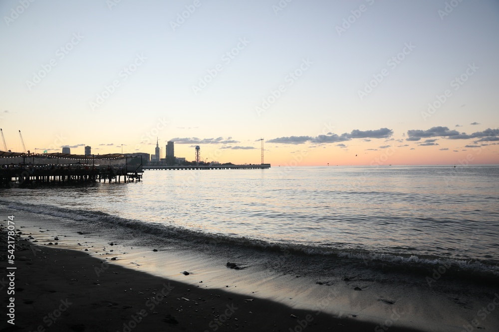 Picturesque view of pier in sea under beautiful sky at sunset