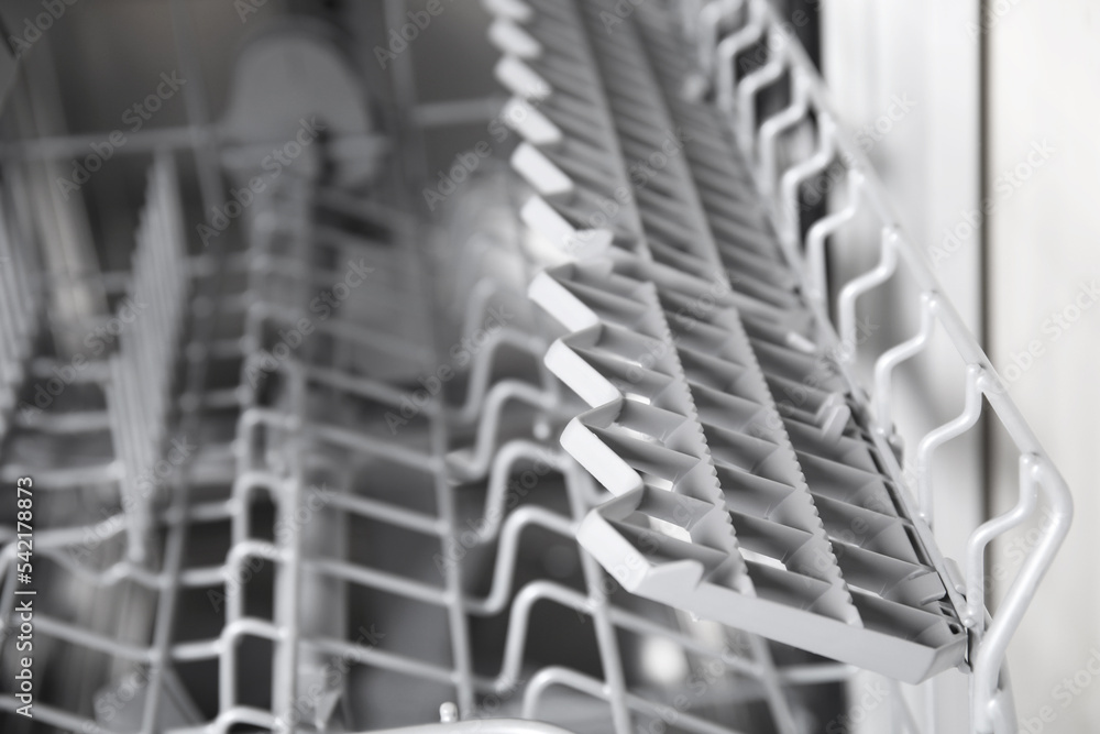 Open clean empty dishwasher in kitchen, closeup Open clean empty dishwasher in kitchen, closeup