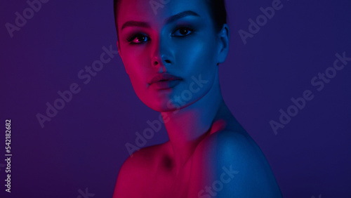 Woman on pink blue neon background.