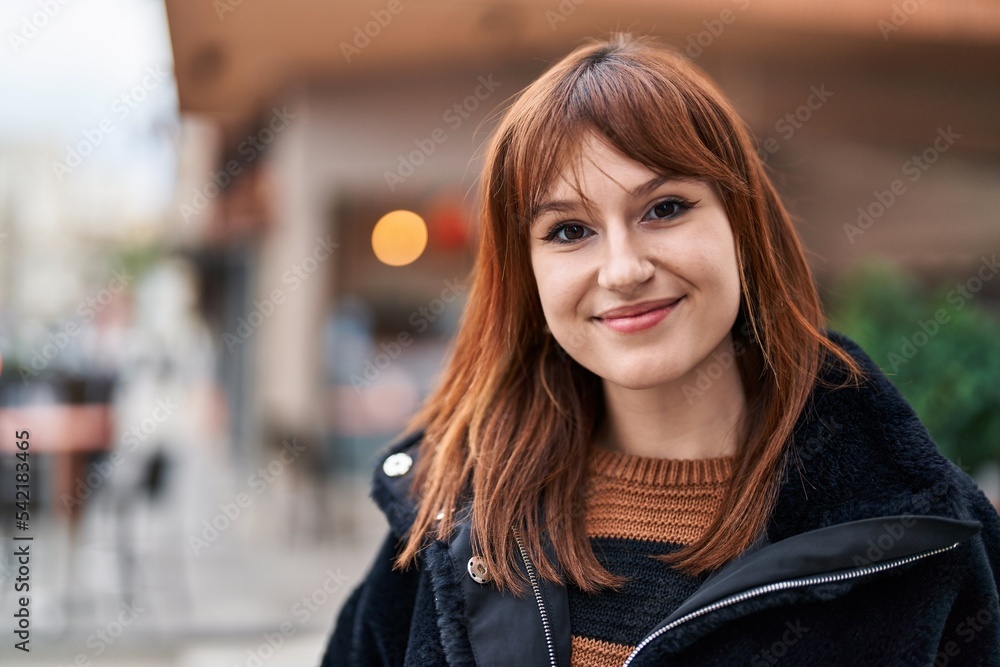 Young woman smiling confident standing at street