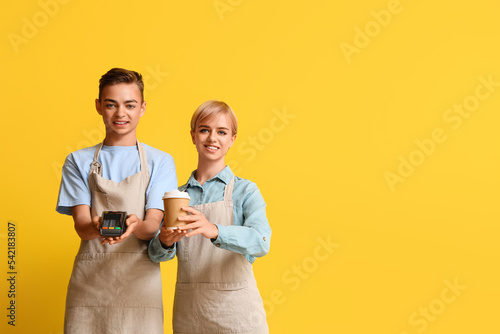 Young baristas with payment...