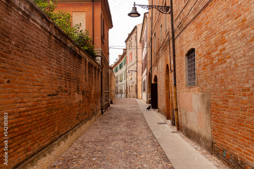 Fototapeta Naklejka Na Ścianę i Meble -  Historic streets of Ferrara, Italy. Narrow streets, historic building facades.