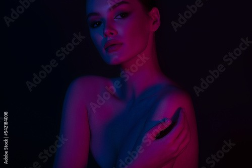 Woman on pink blue neon background.