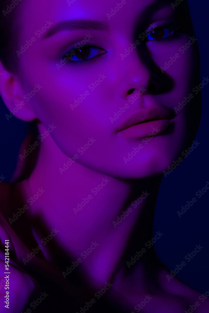 Woman on lilac neon background.