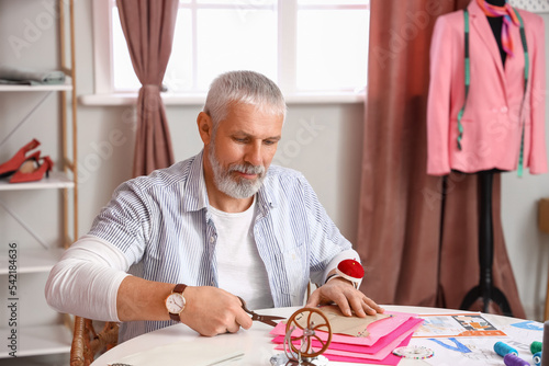 Mature fashion designer cut...