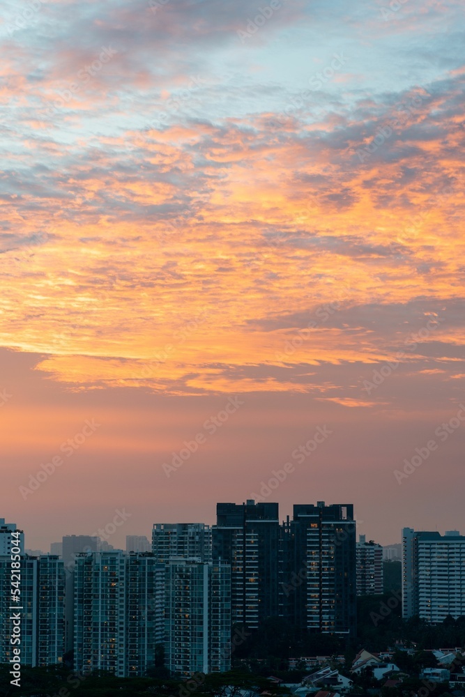 Vertical shot of a beautiful sunset over the residential building