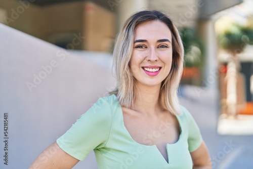 Young woman smiling confident standing at street Free Download Young woman smiling confident standing at street - GFXLoad