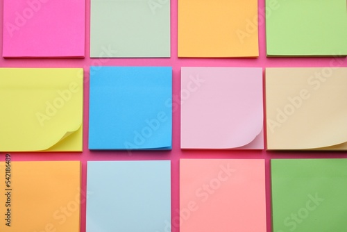Colorful empty notes on pink background, flat lay