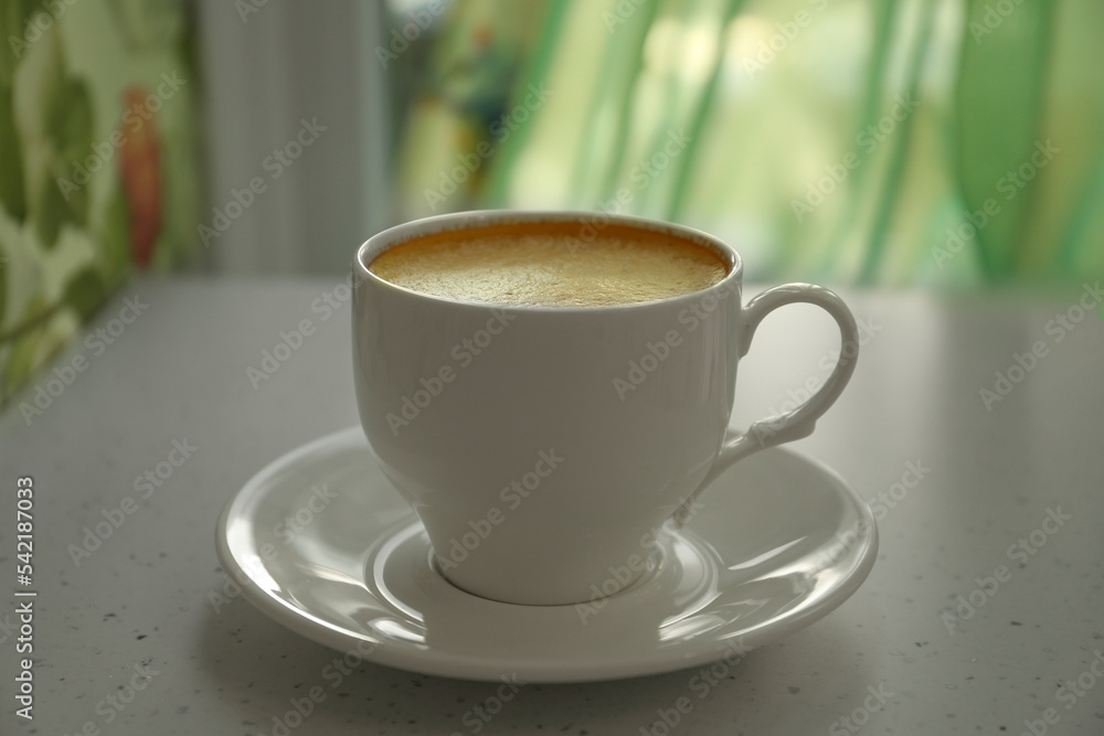 Cup of delicious aromatic coffee on white table indoors