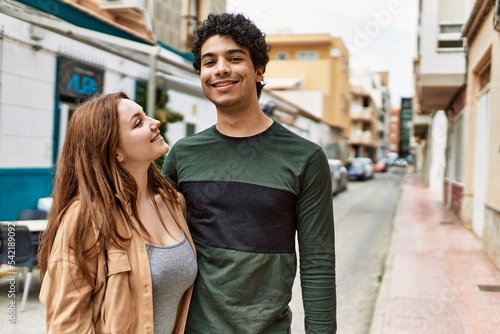 Young interracial couple smiling happy and hugging standing at the city. © Krakenimages.com