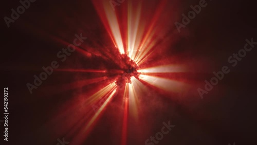 Abstract blood-red dense clouds flying before the sun. Rays of the sun breaking through the clouds.
