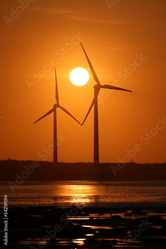 Windmills and sunset at Gaomei Wetland in Taichung, Taiwan.