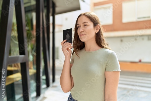 Young beautiful woman smiling confident holding canada passport at street Free Download Young beautiful woman smiling confident holding canada passport at street - GFXLoad
