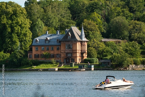 View of Sirishov Villa on Djurgarden island in Stockholm with Rosendal Castle and trees on the coast photo