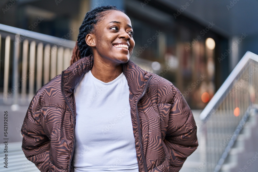 Fototapeta premium African american woman smiling confident looking to the side at street