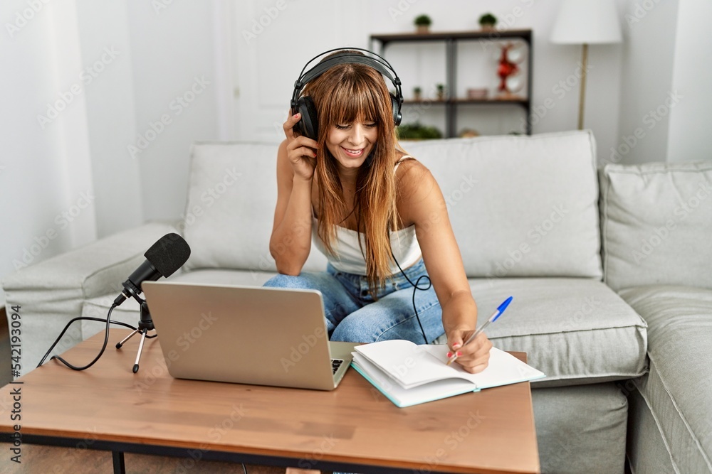 Young hispanic woman smiling confident using laptop and microphone at home Young hispanic woman smiling confident using laptop and microphone at home