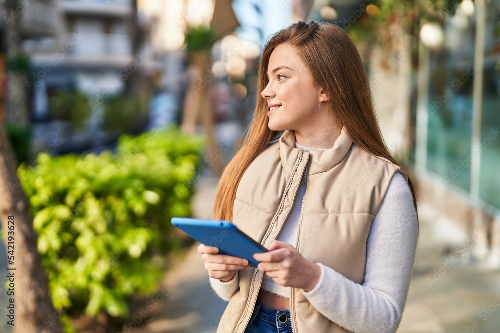 Young blonde woman smiling confident using touchpad at street Young blonde woman smiling confident using touchpad at street