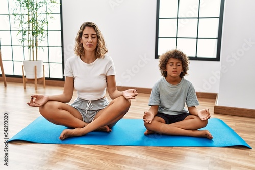 Mother and son training yoga at sport center