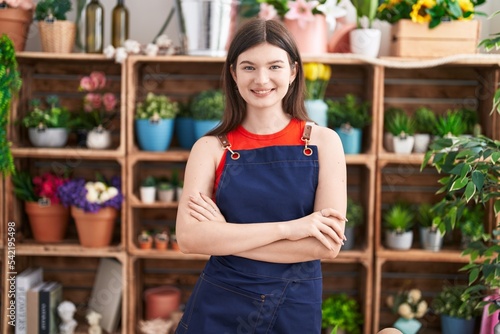 Young caucasian woman florist smiling confident standing with arms crossed gesture at florist